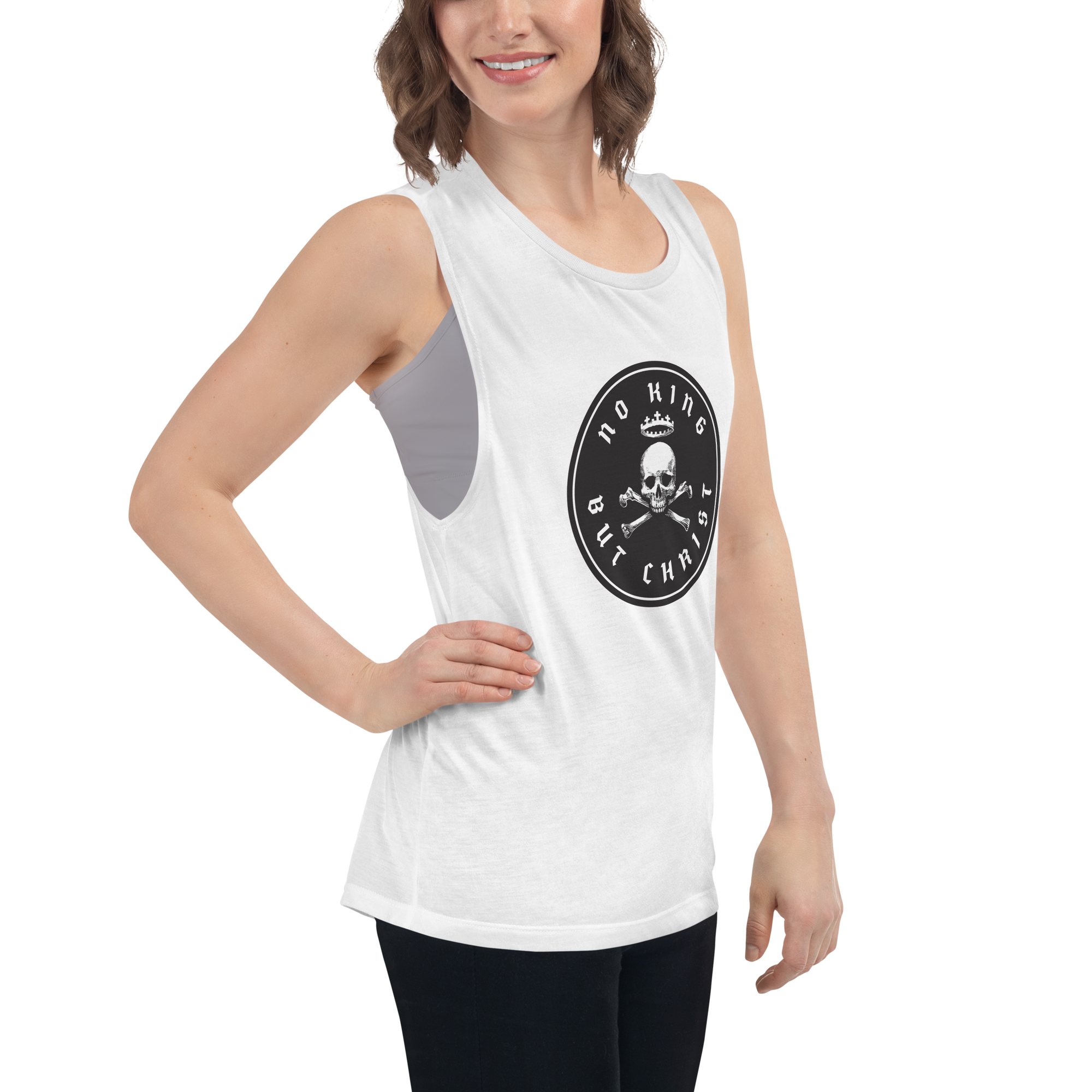 Woman posing with hand on hip wearing white No King But Christ seal women's flowy muscle tank featuring black crowned skull-and-crossbones emblem, faith-based apparel by Glenn Beck Shop