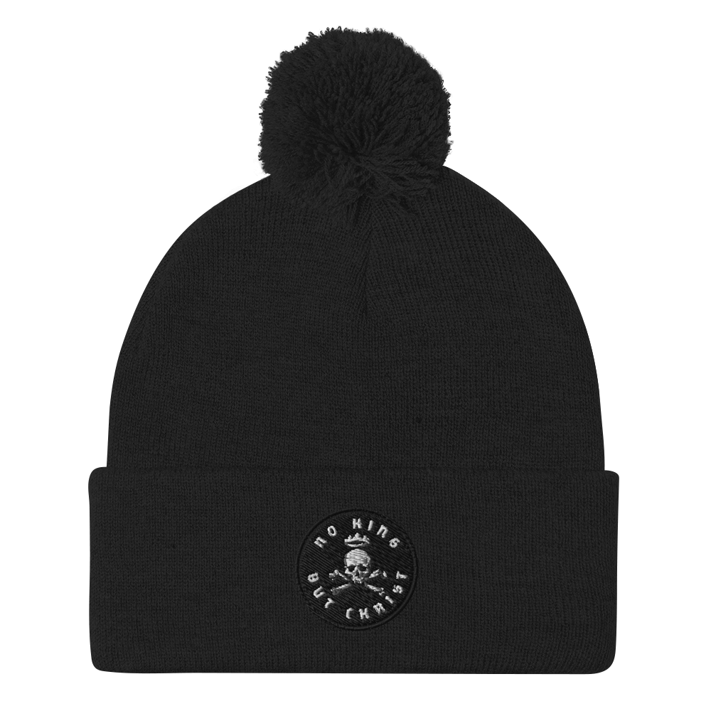 No King But Christ Pom-Pom Beanie black front view – cozy embroidered winter cap with pom-pom